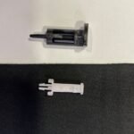 Two small plastic components on surface
