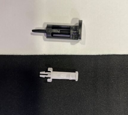 Two small plastic components on surface